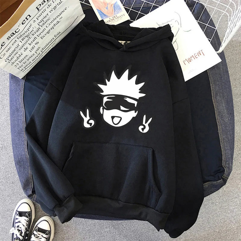 Sweat à capuche noir, motif visage démon avec cornes et mains, au centre.